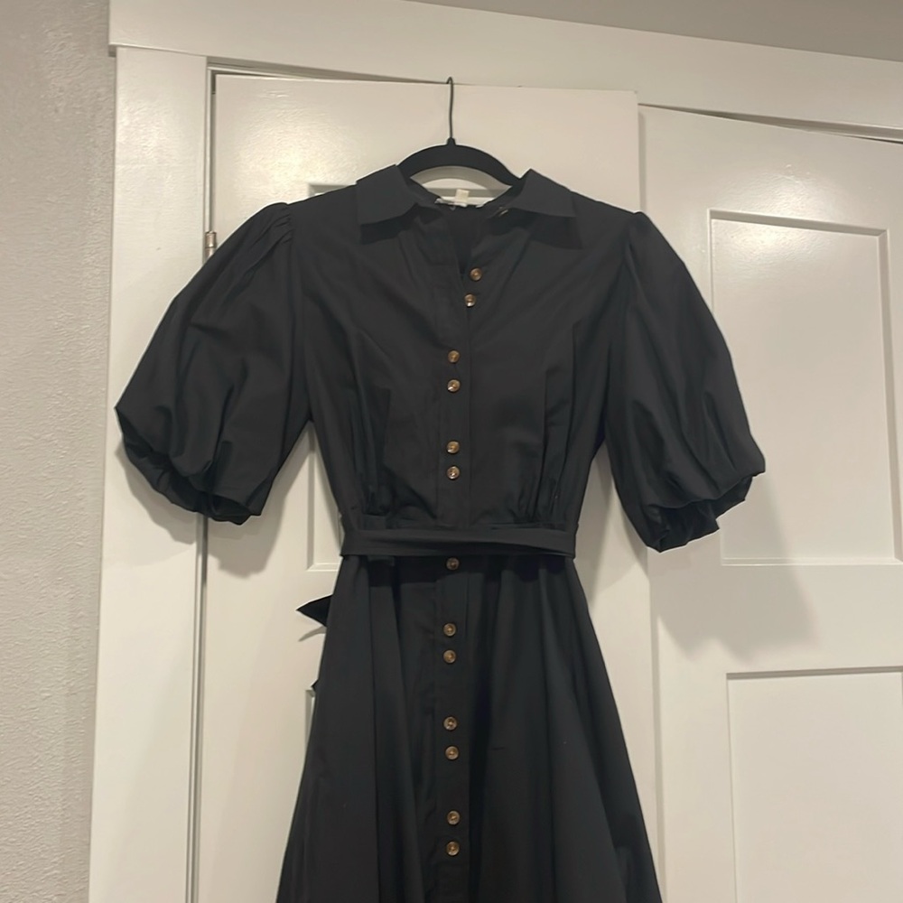 Women’s midi black dress with puffer sleeves.